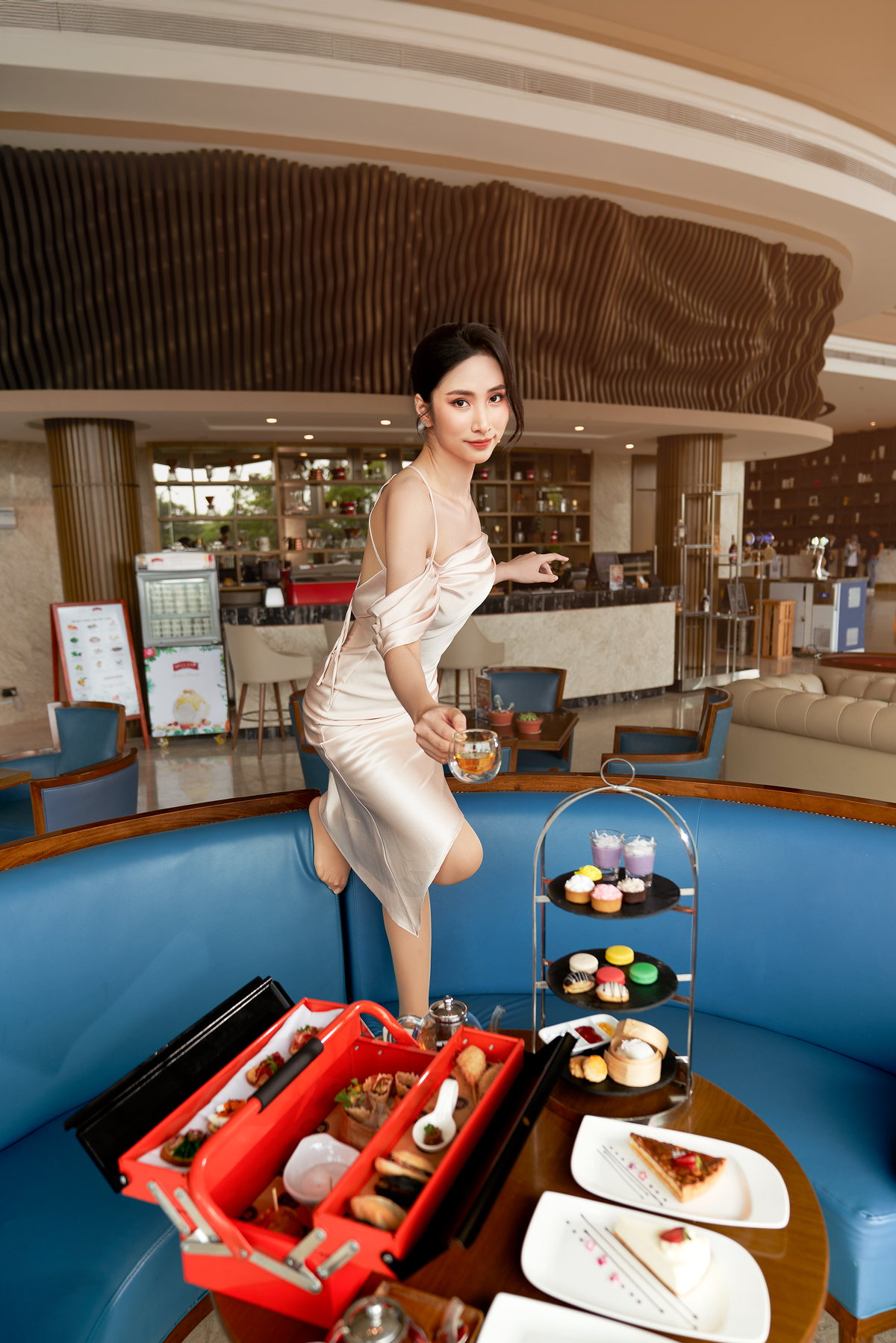 Một vị khách bên bàn bánh ngọt và trà chiều tại Four Points Danang